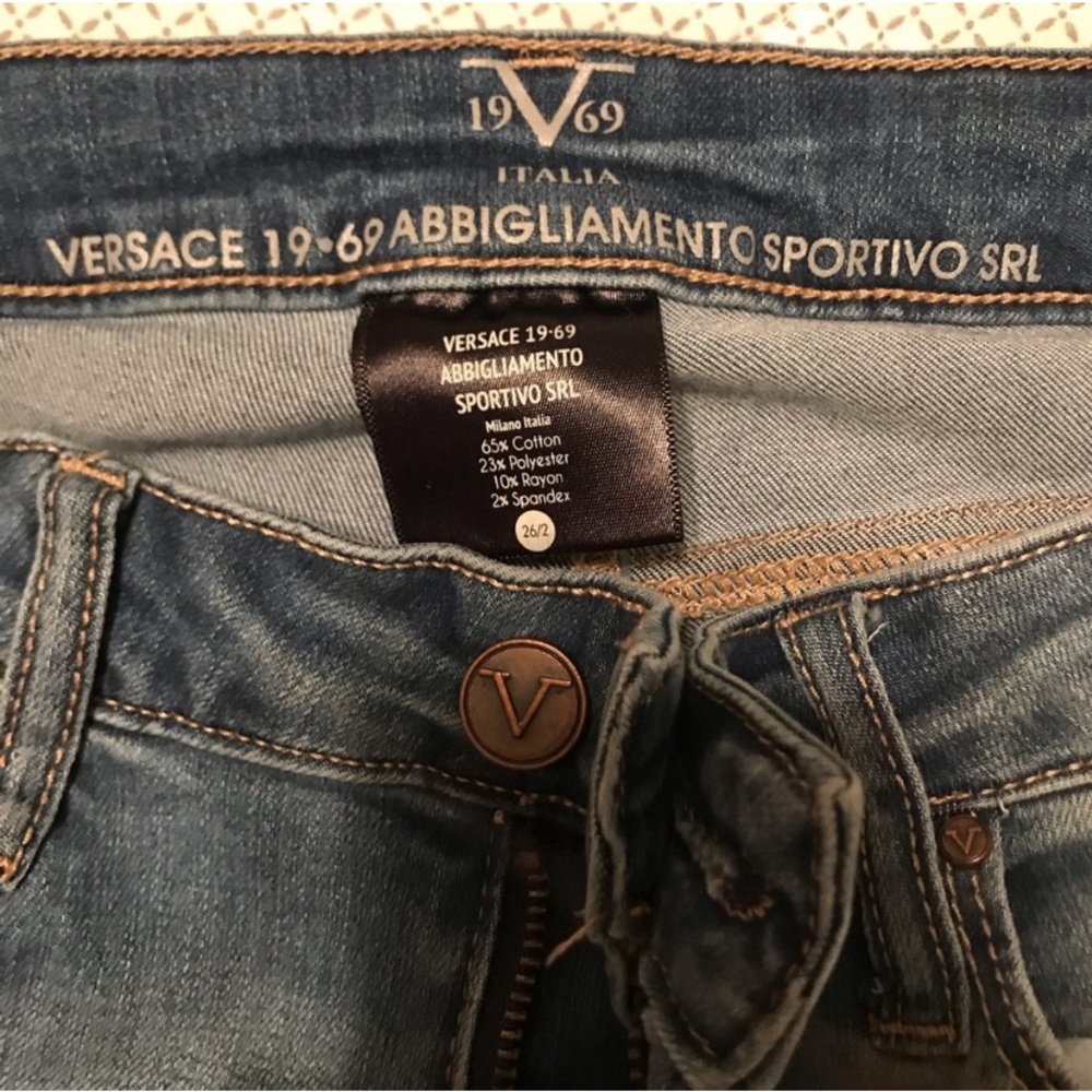Versace distressed skinny jeans with ankle zip.